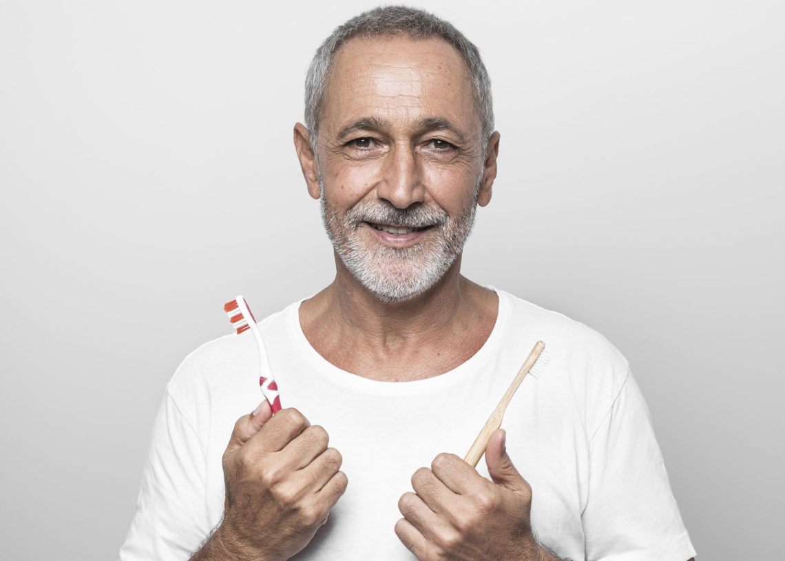 man-holding-toothbrushes