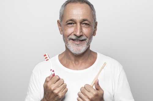 man-holding-toothbrushes